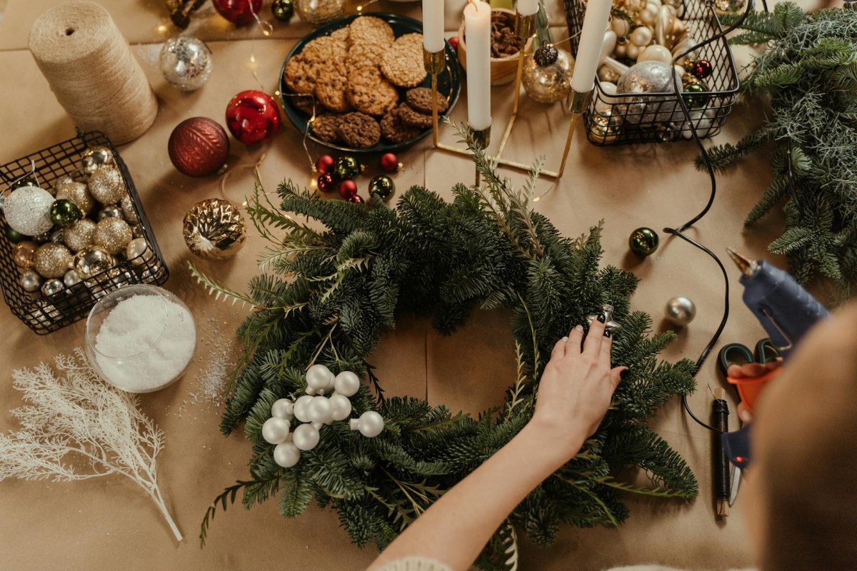 A person making a Christmas wreath. Photo by Cottonbro Studio via Pexels